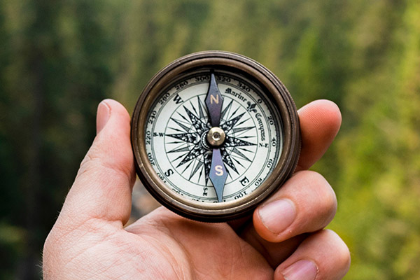 hand holding a compass